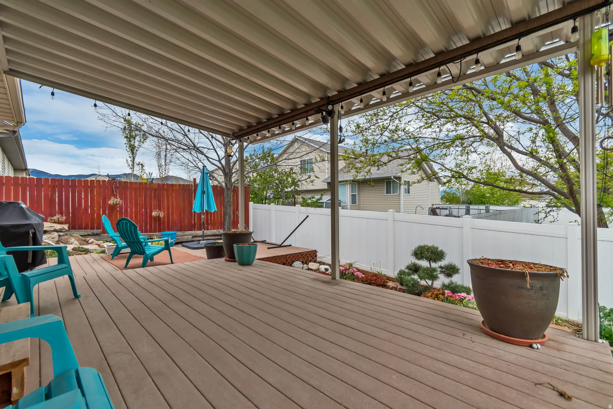 Three-tiered deck featuring a fenced backyard, grilling area, fire pit space, perimeter lighting and shade screens.  Perfectly setting for rest and relaxation.