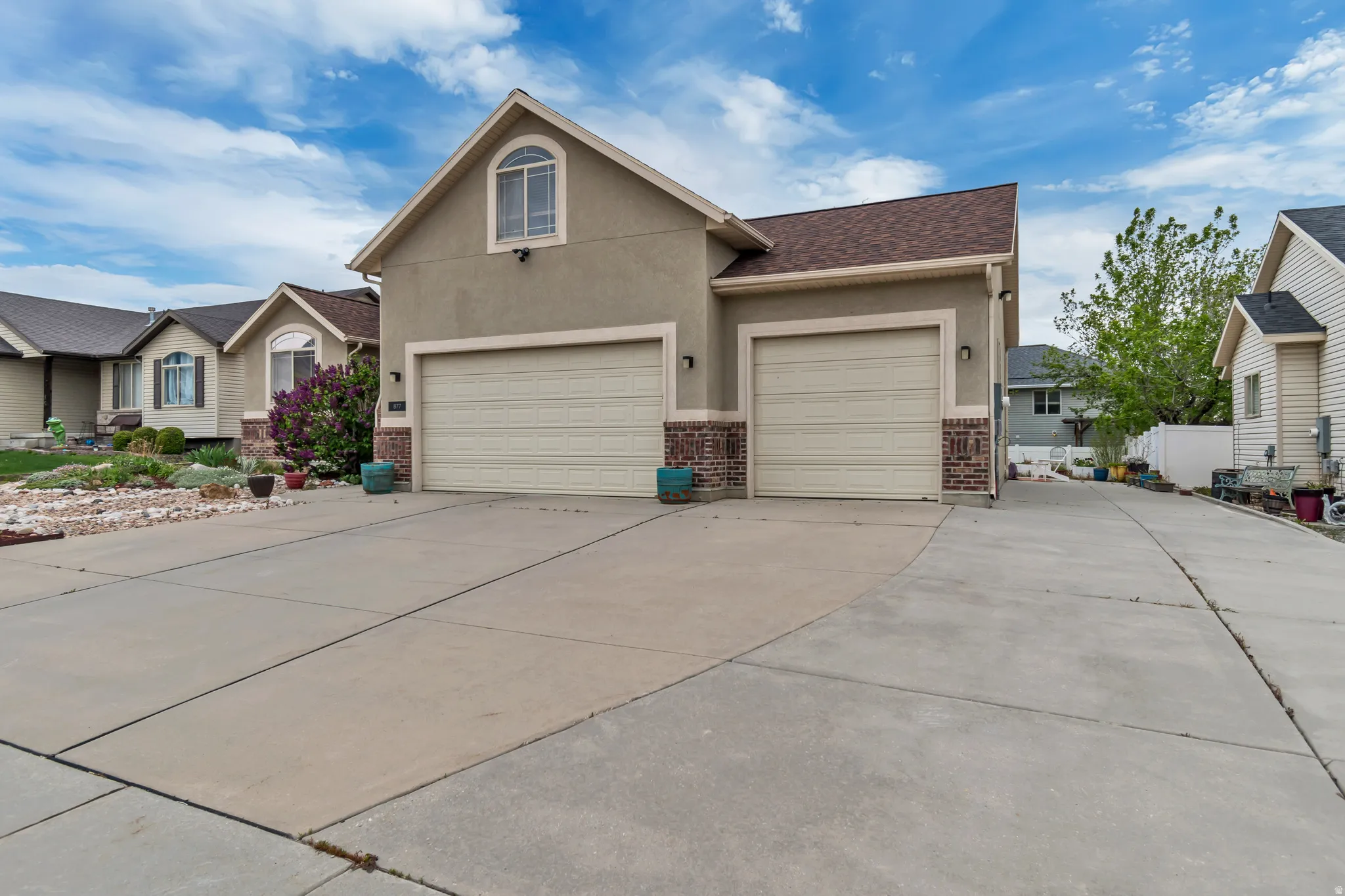 Angled-view of  front of house featuring concrete driveway and extra RV parking.