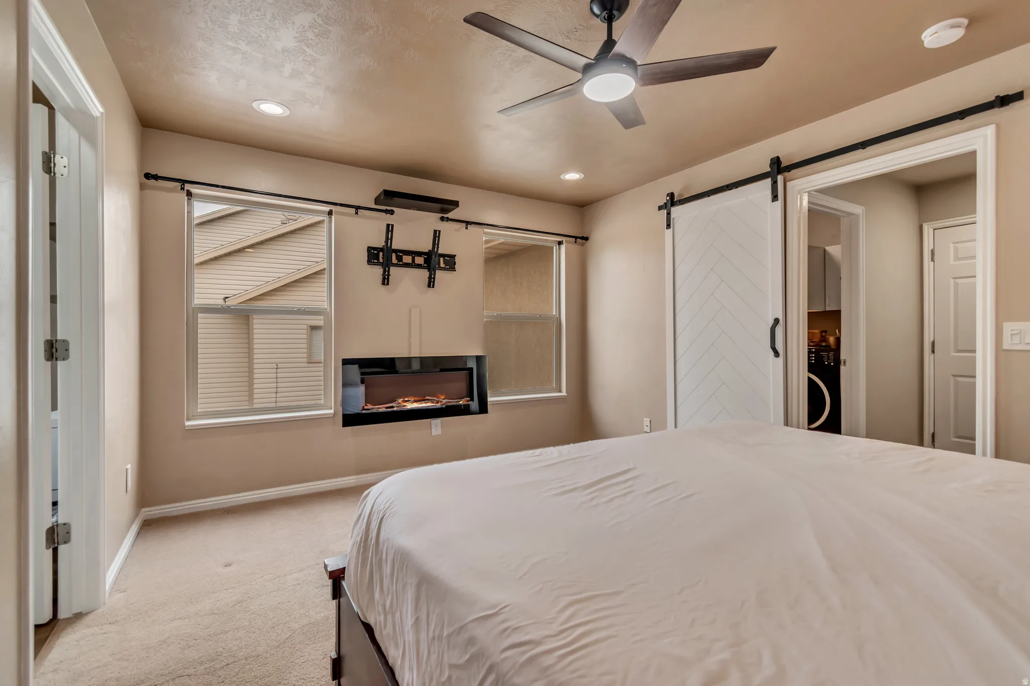 Another view of the first-floor master with built-in fireplace for total comfort and style.