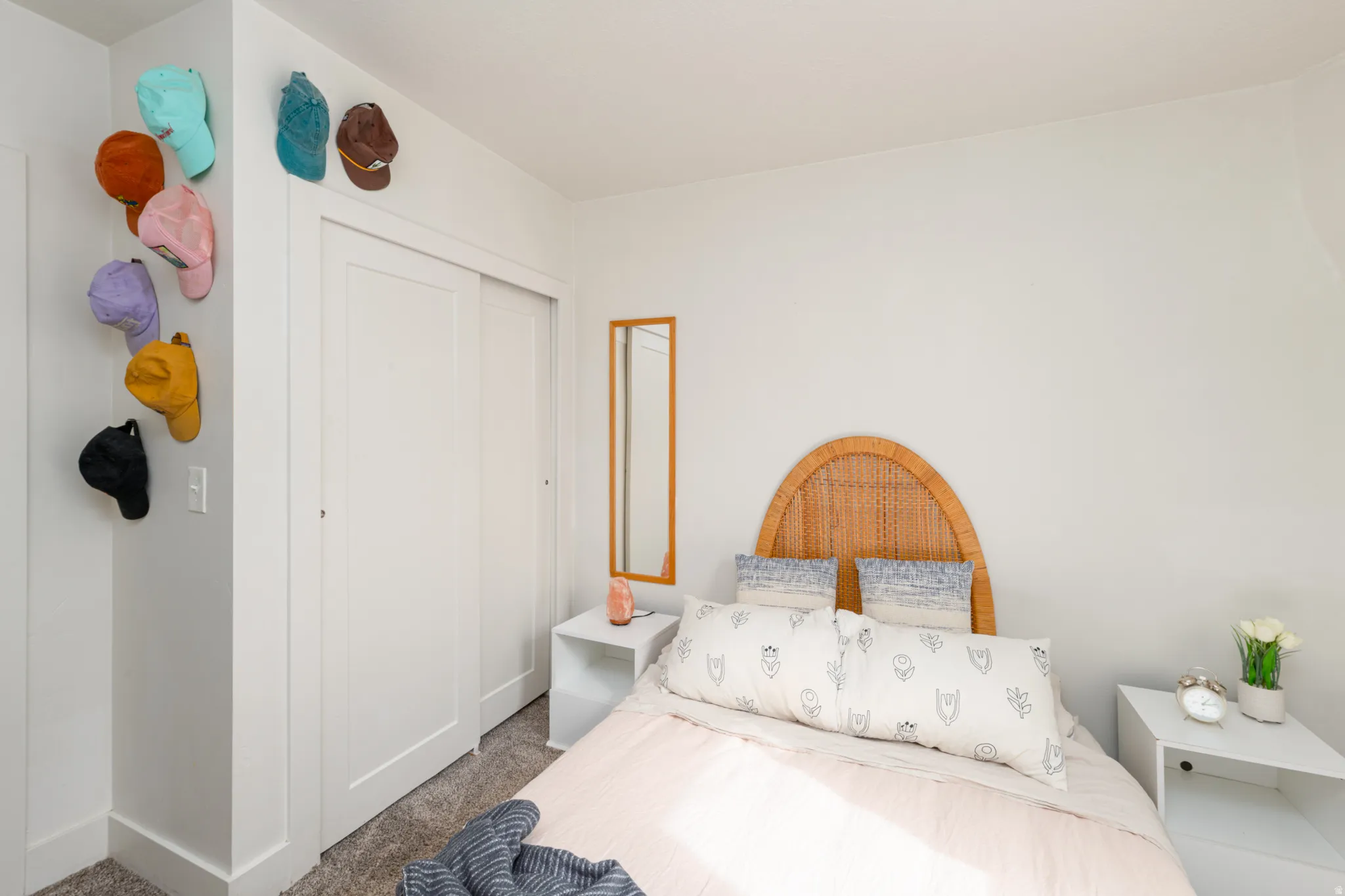 Primary bedroom with carpet, a closet, and lots of natural light.