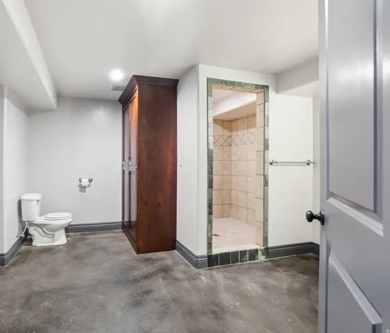 Walk-in shower with tiled surround and decorative accents