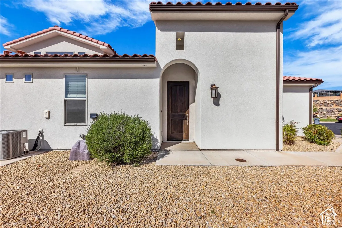View of exterior entry featuring stucco siding