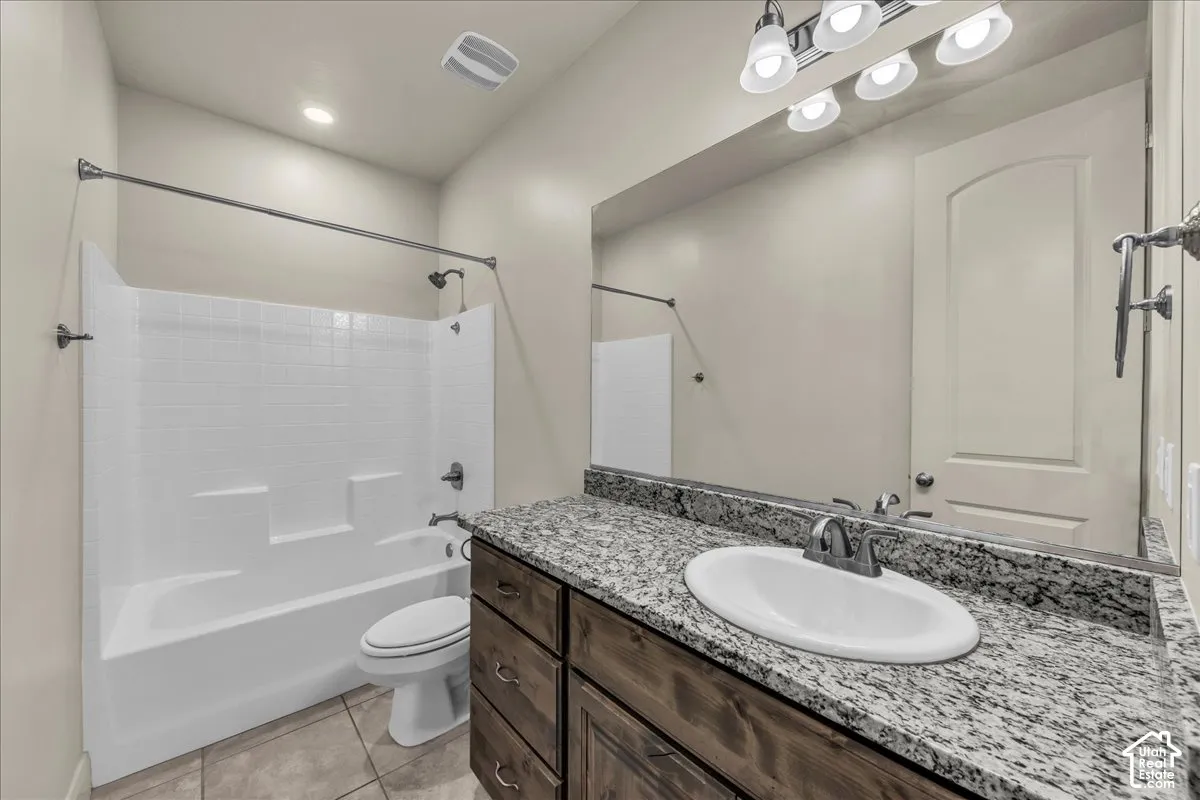 Full bathroom with vanity, bathtub / shower combination, light tile patterned floors, and recessed lighting