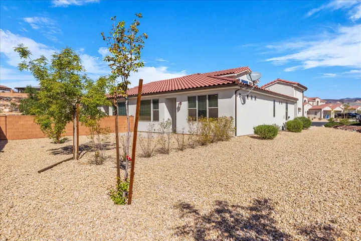 Back of property featuring stucco siding and a tile roof