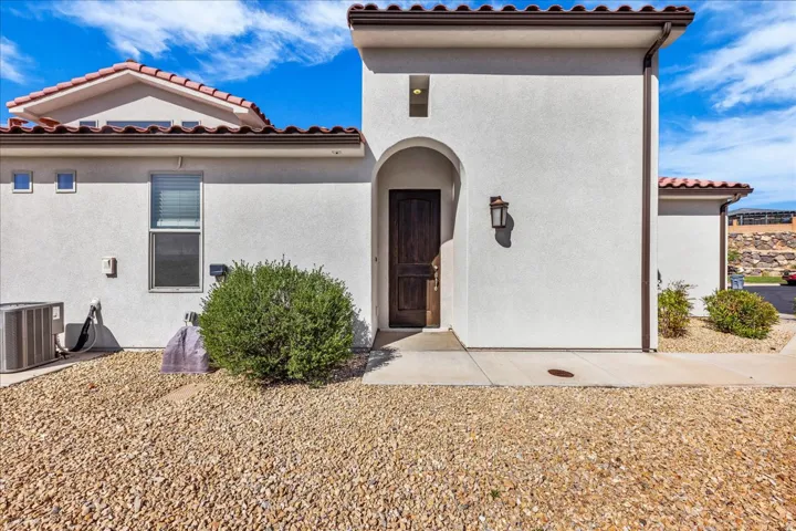 View of exterior entry featuring stucco siding