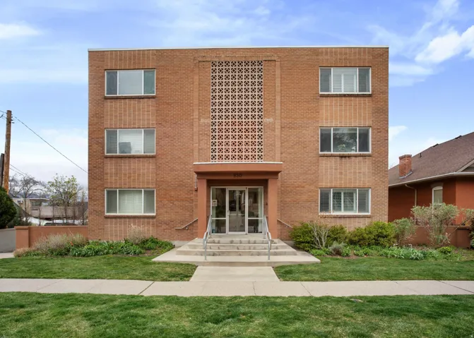 View of front of home with brick siding and a front lawn