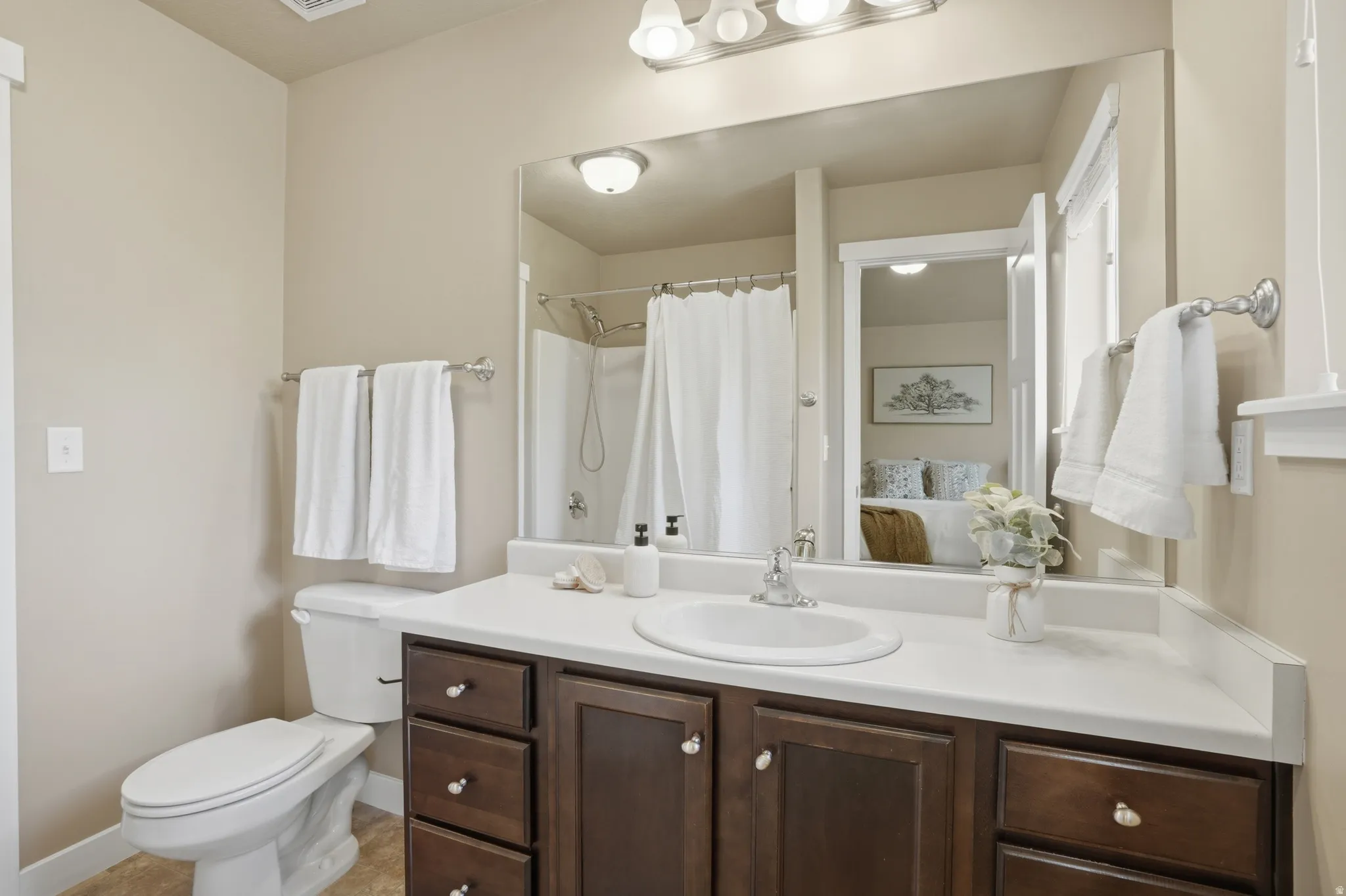 Full bathroom featuring vanity, a shower with curtain, and ensuite bath