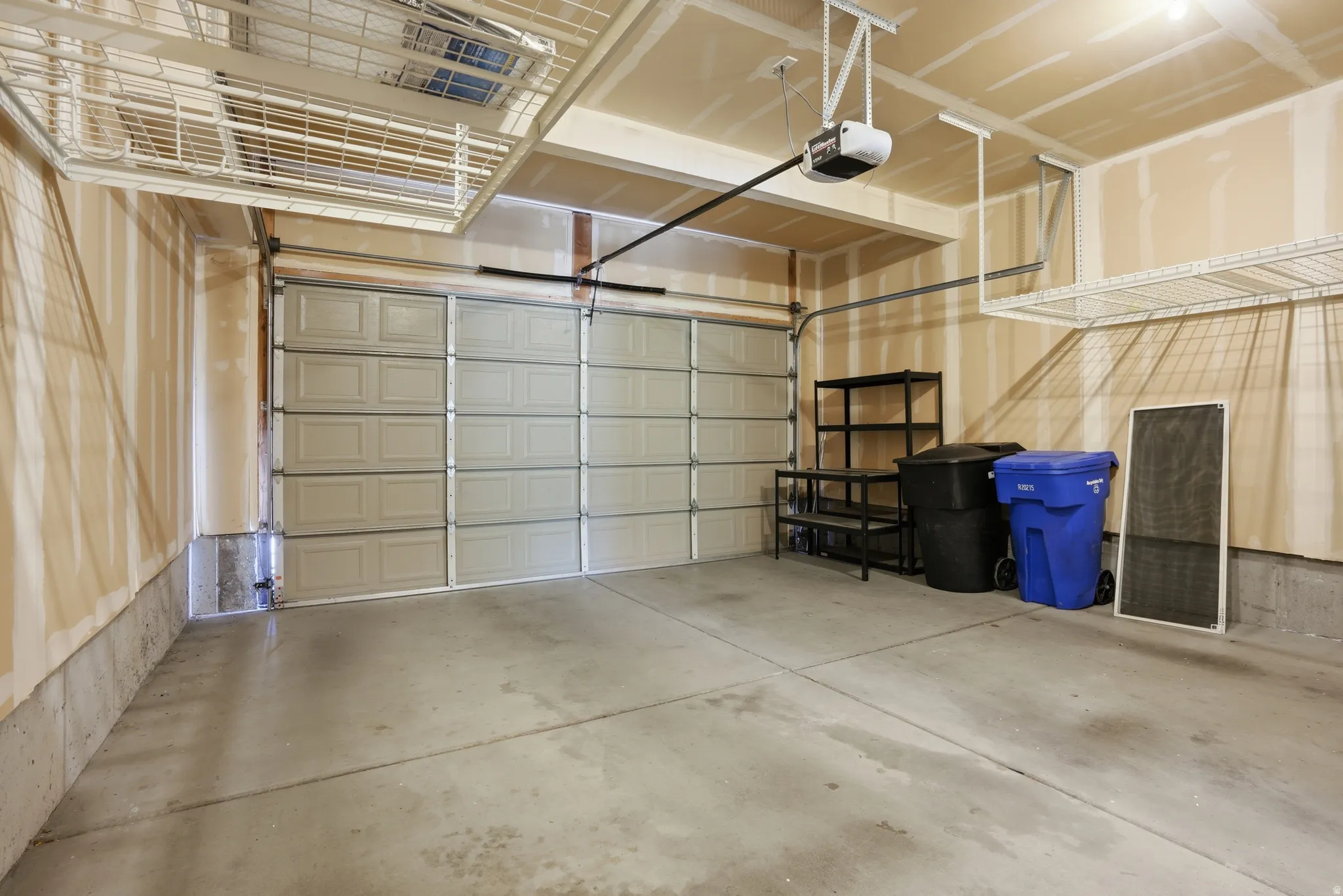 Garage featuring a garage door opener