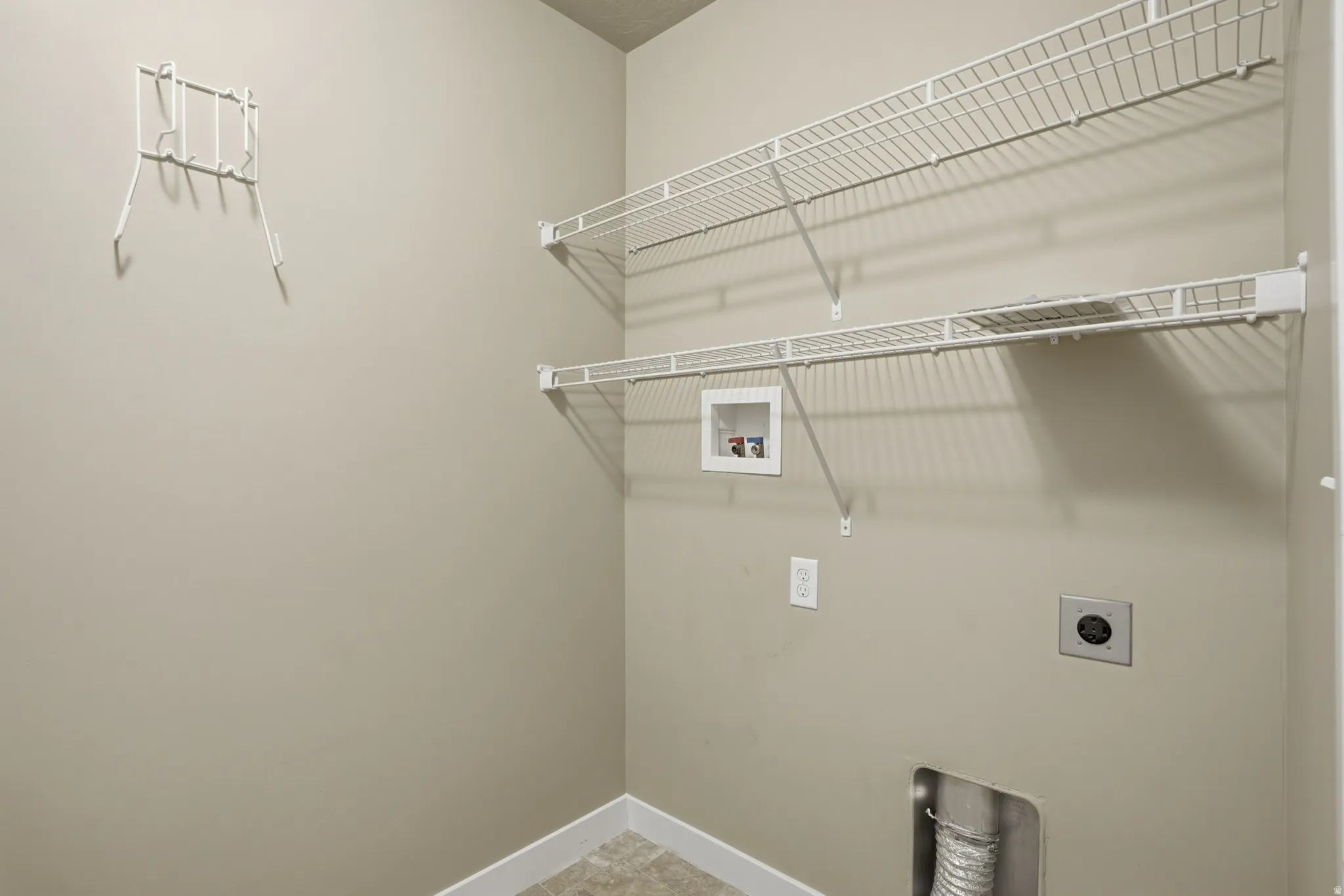 Laundry room with hookup for a washing machine and hookup for an electric dryer