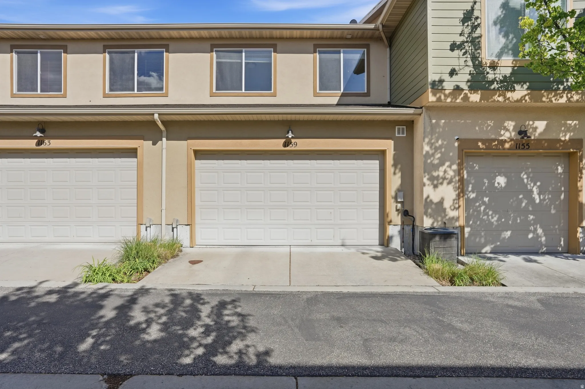 Traditional-style house featuring stucco siding, a garage, and concrete driveway