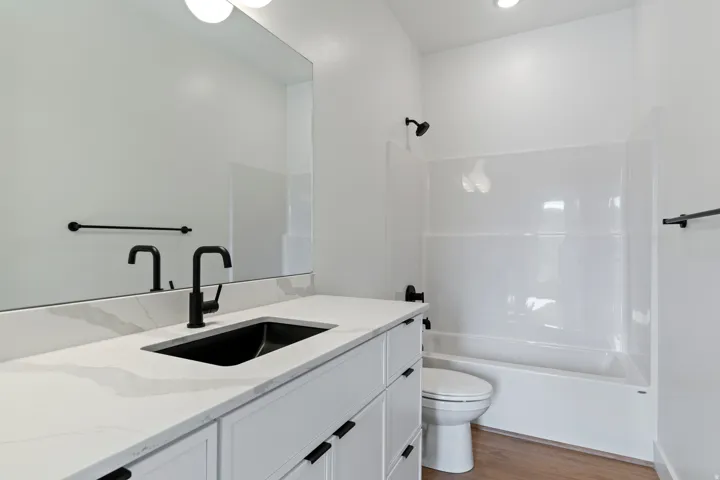 Bathroom featuring vanity, light wood-type flooring, and shower / tub combination