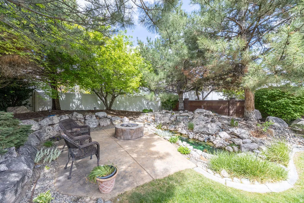 Fenced backyard featuring a patio area and a fire pit