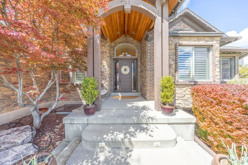 Property entrance featuring stone siding and brick siding