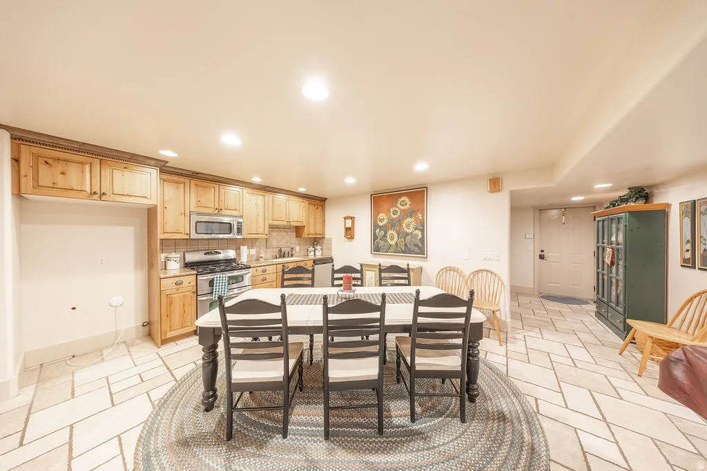 Dining space featuring recessed lighting and stone tile floors