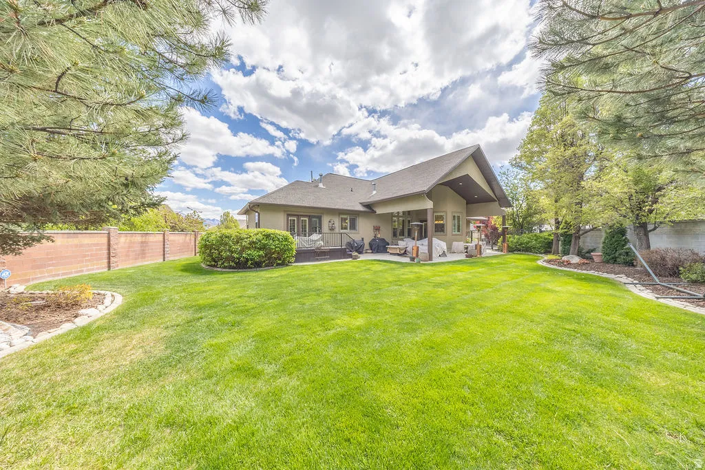 Rear view of property featuring a fenced backyard, a patio area, and stucco siding