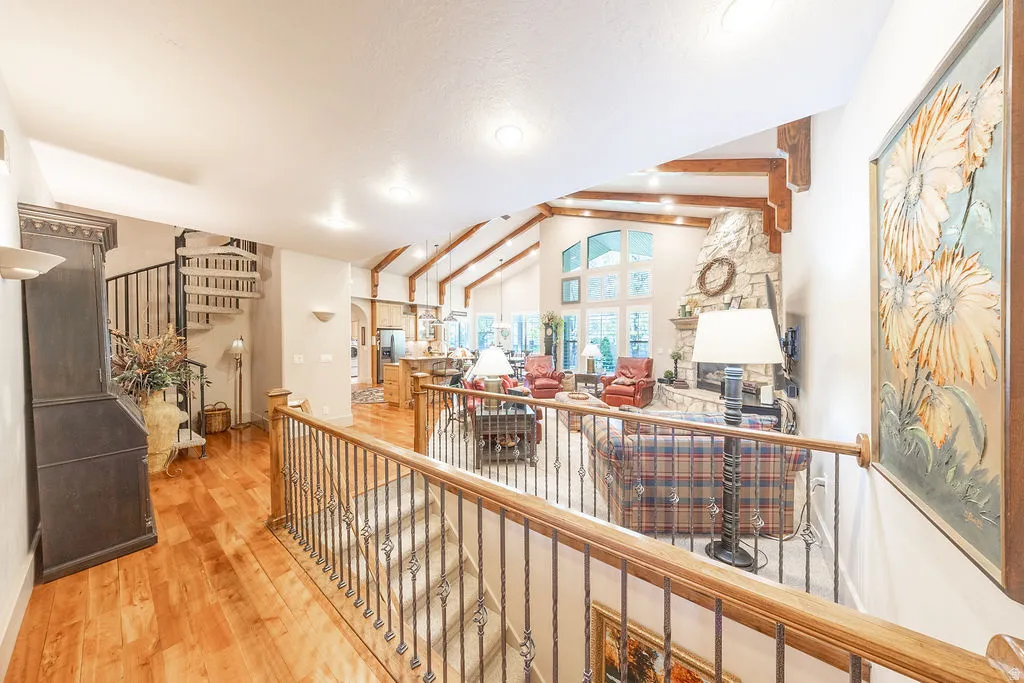 Hall featuring hardwood / wood-style floors and vaulted ceiling with beams