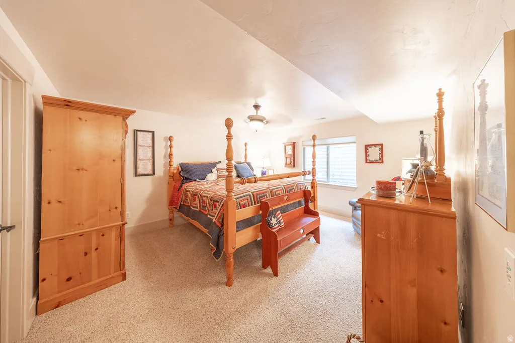 Bedroom featuring light colored carpet and ceiling fan