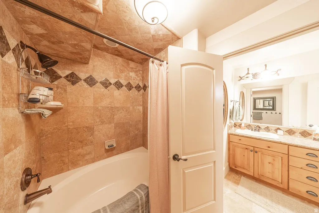 Full bathroom with vanity and shower / tub combo with curtain
