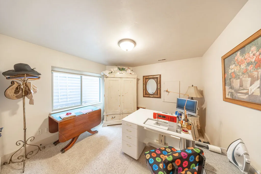 Office with light carpet and baseboards