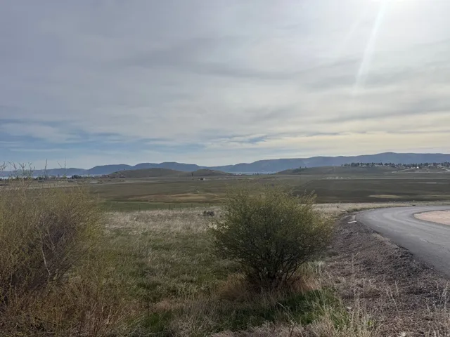 View of mountain background featuring rural landscape