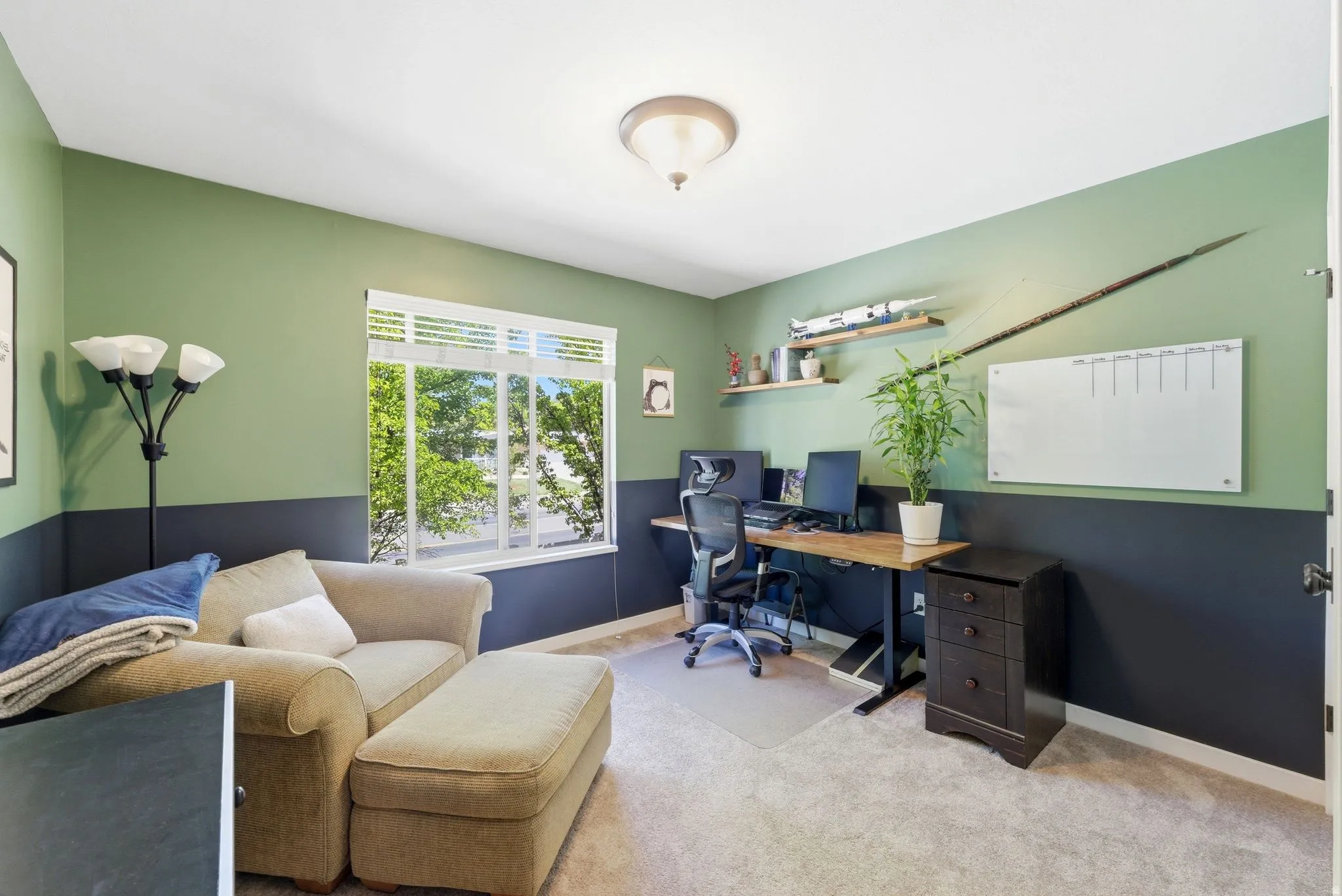 Office area featuring light carpet and baseboards