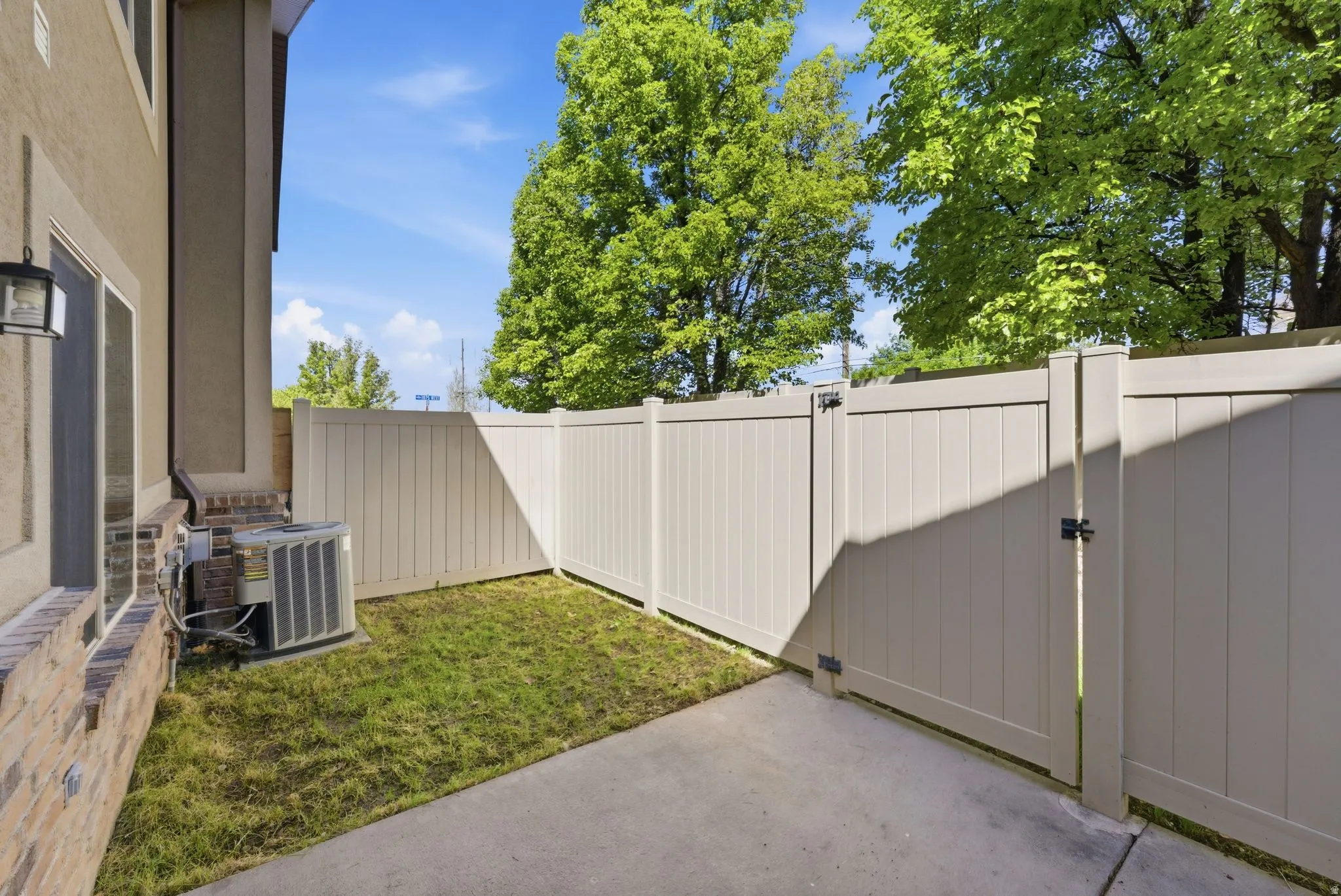 Fenced yard with a gate and a patio