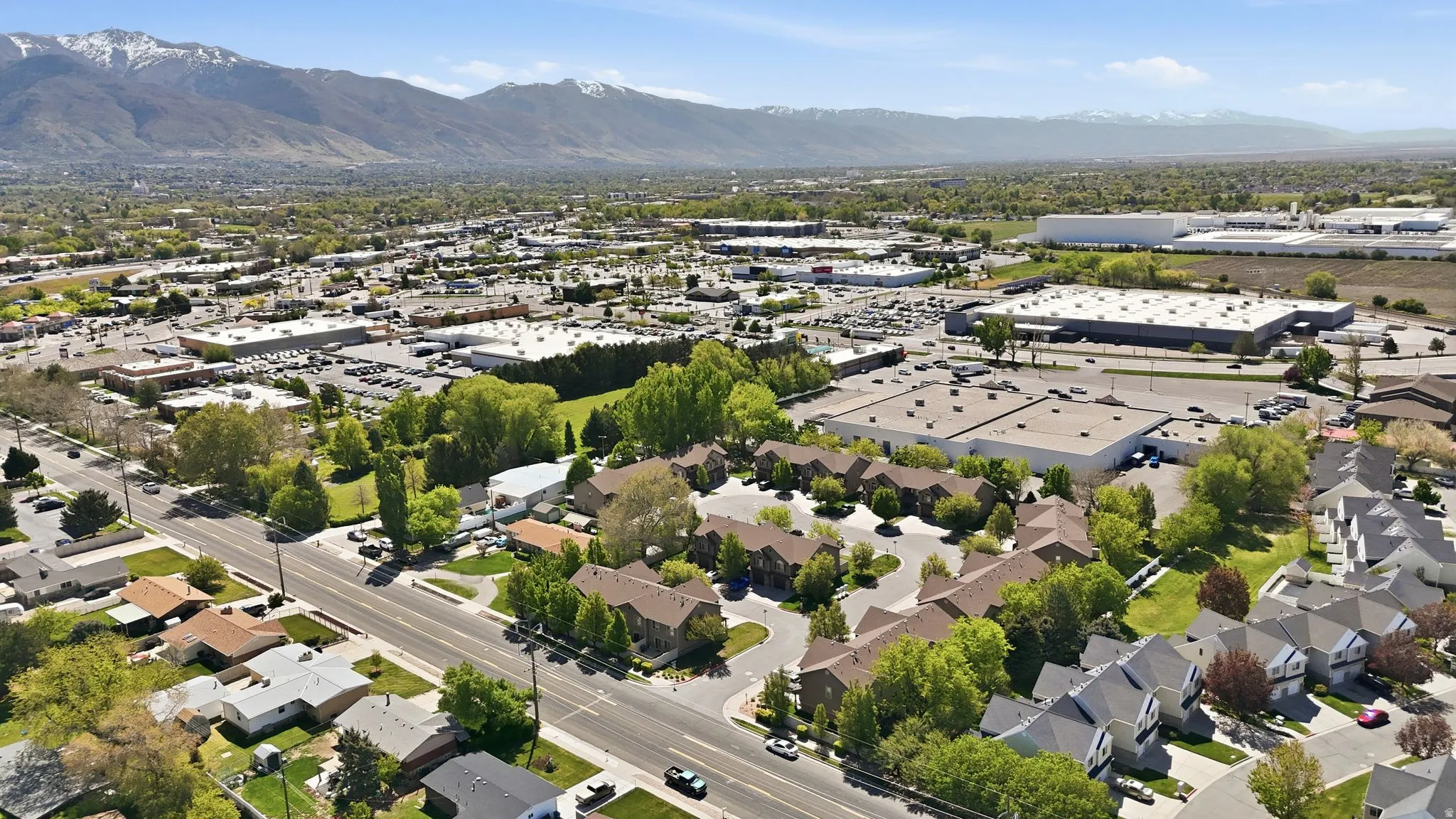 Aerial view of residential area featuring a mountainous background