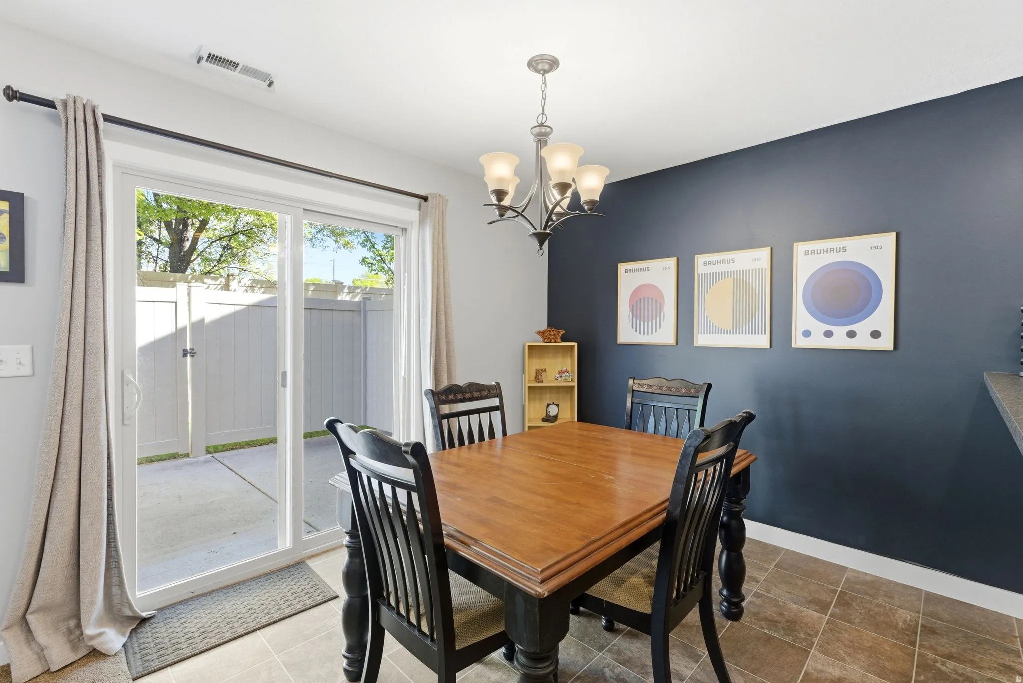Dining room with hanging lights and baseboards