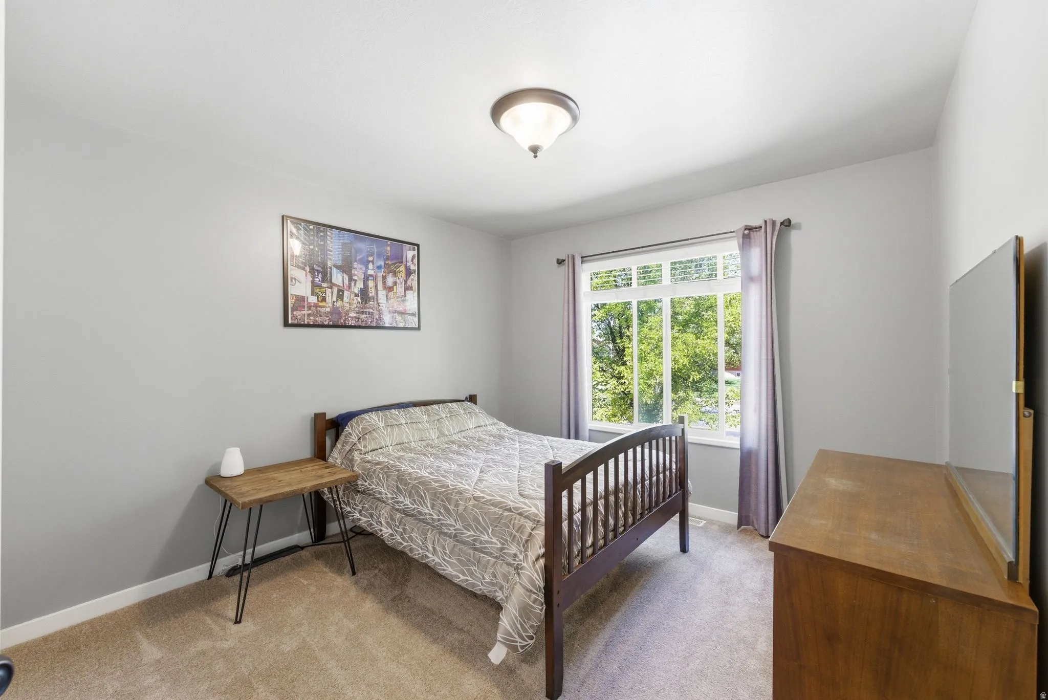 Bedroom featuring light colored carpet