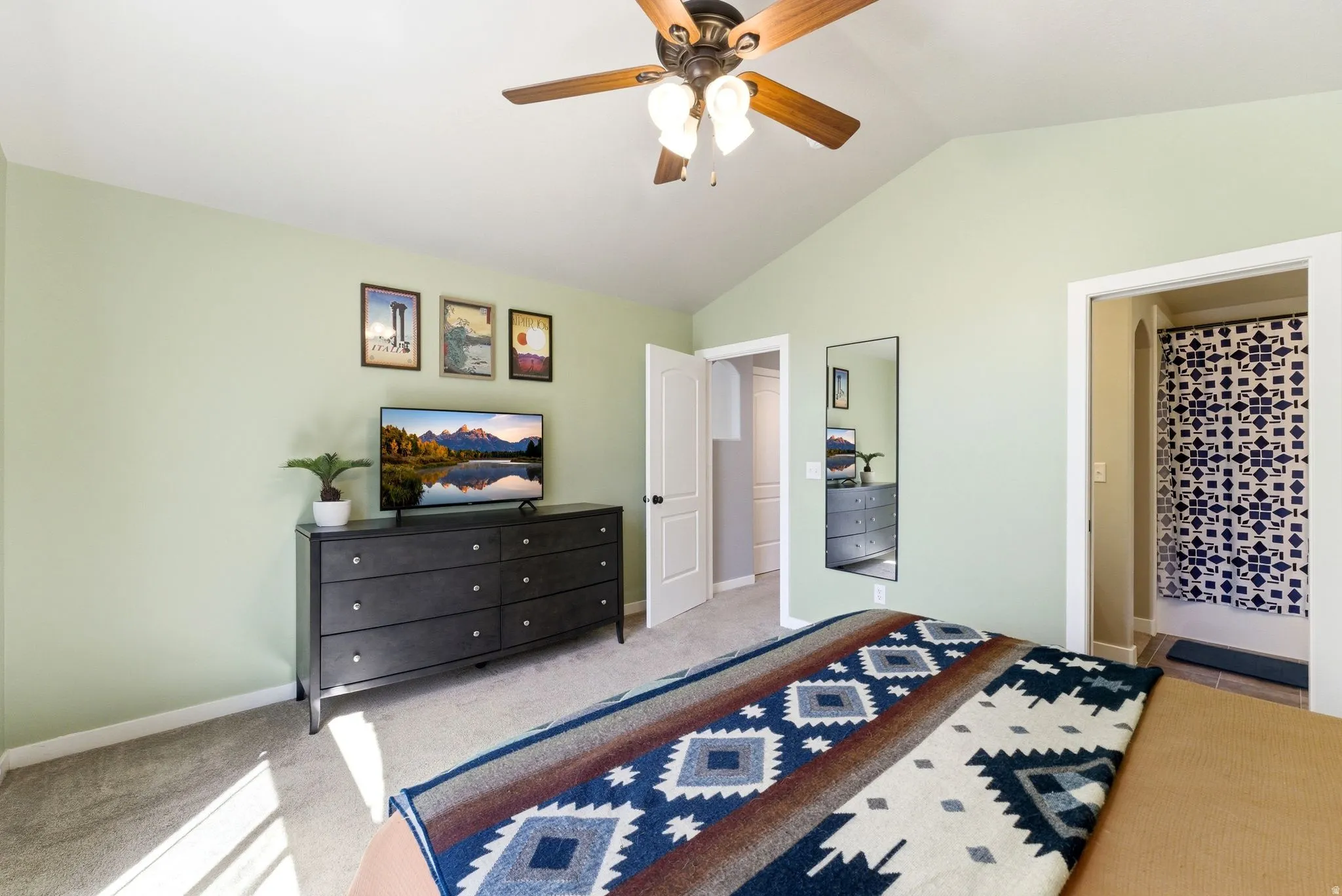 Bedroom with a ceiling fan and light carpet