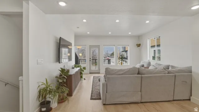 Living area featuring light wood-style flooring, recessed lighting, and a textured ceiling