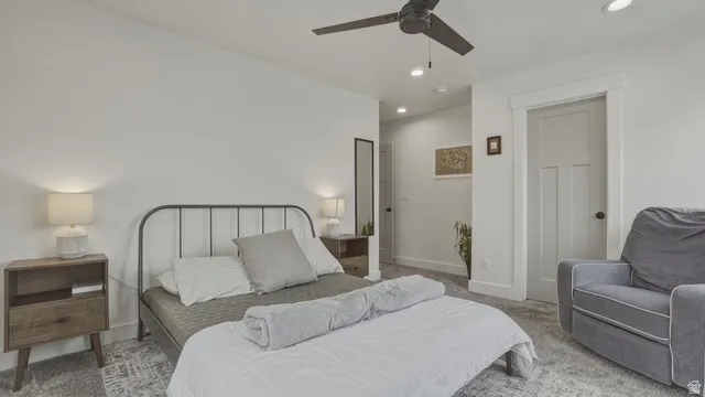 Bedroom with carpet, ceiling fan, and recessed lighting