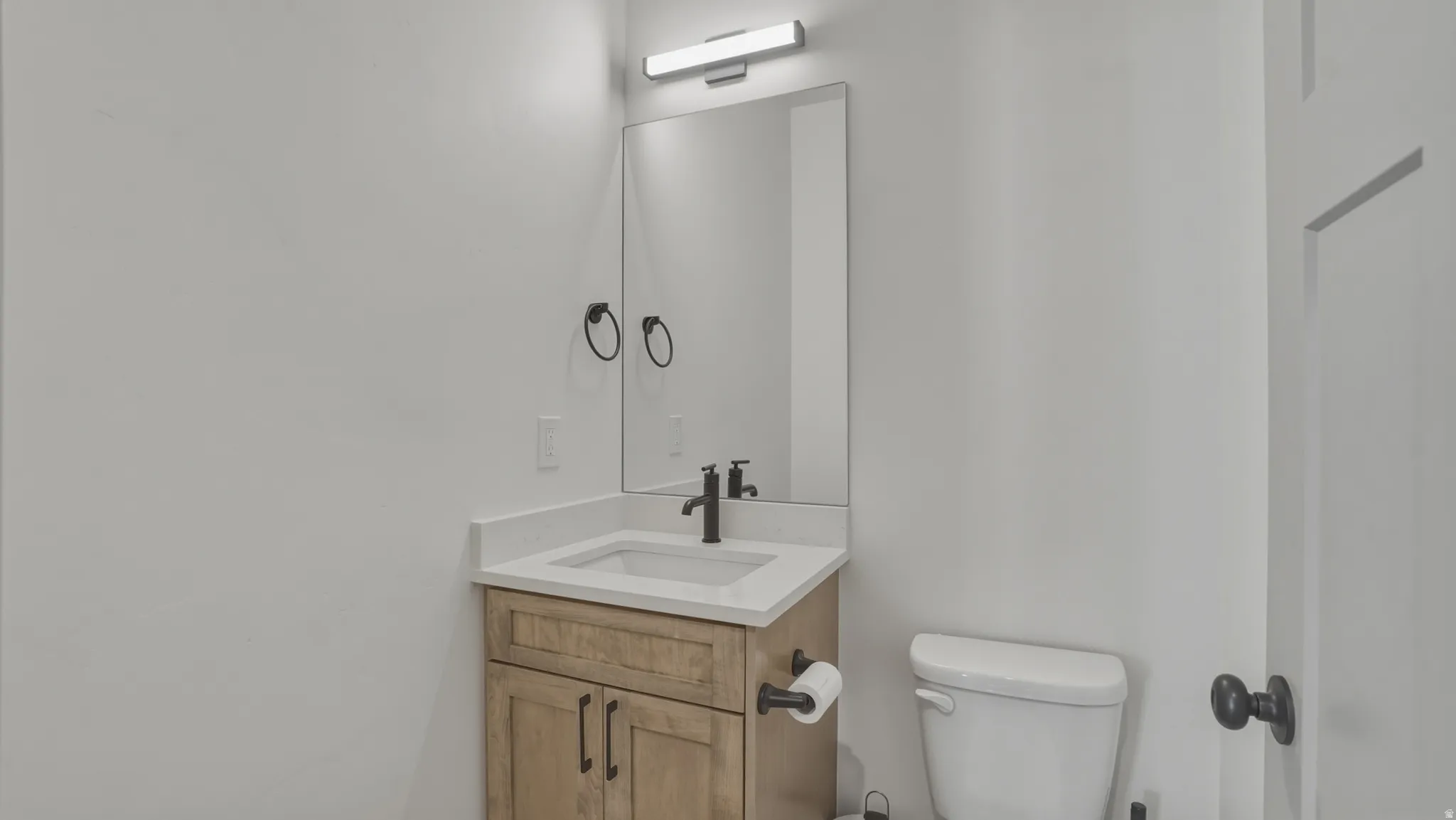 Half bath with vanity and toilet