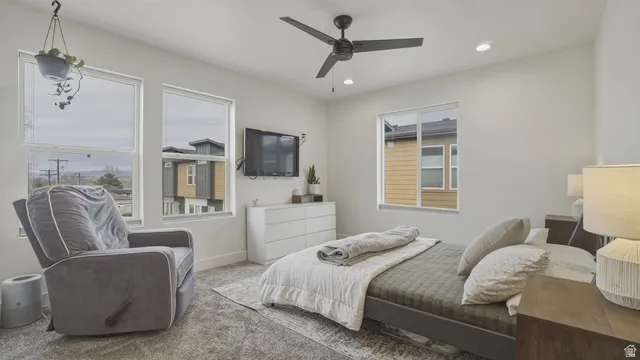 Bedroom with carpet flooring, ceiling fan, and recessed lighting