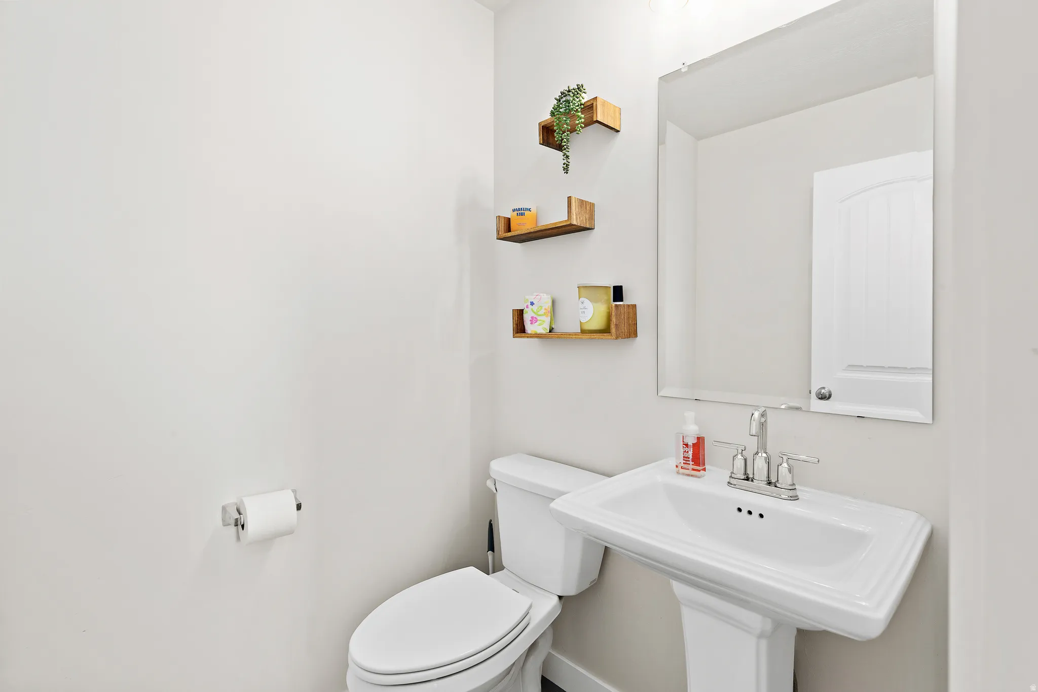 Half bath featuring toilet and a sink