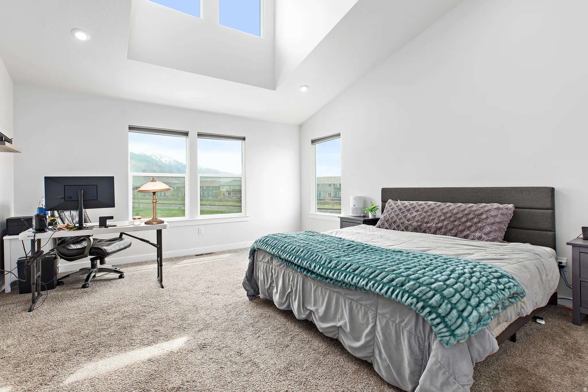 Bedroom featuring carpet floors, a desk, multiple windows, recessed lighting, and lofted ceiling