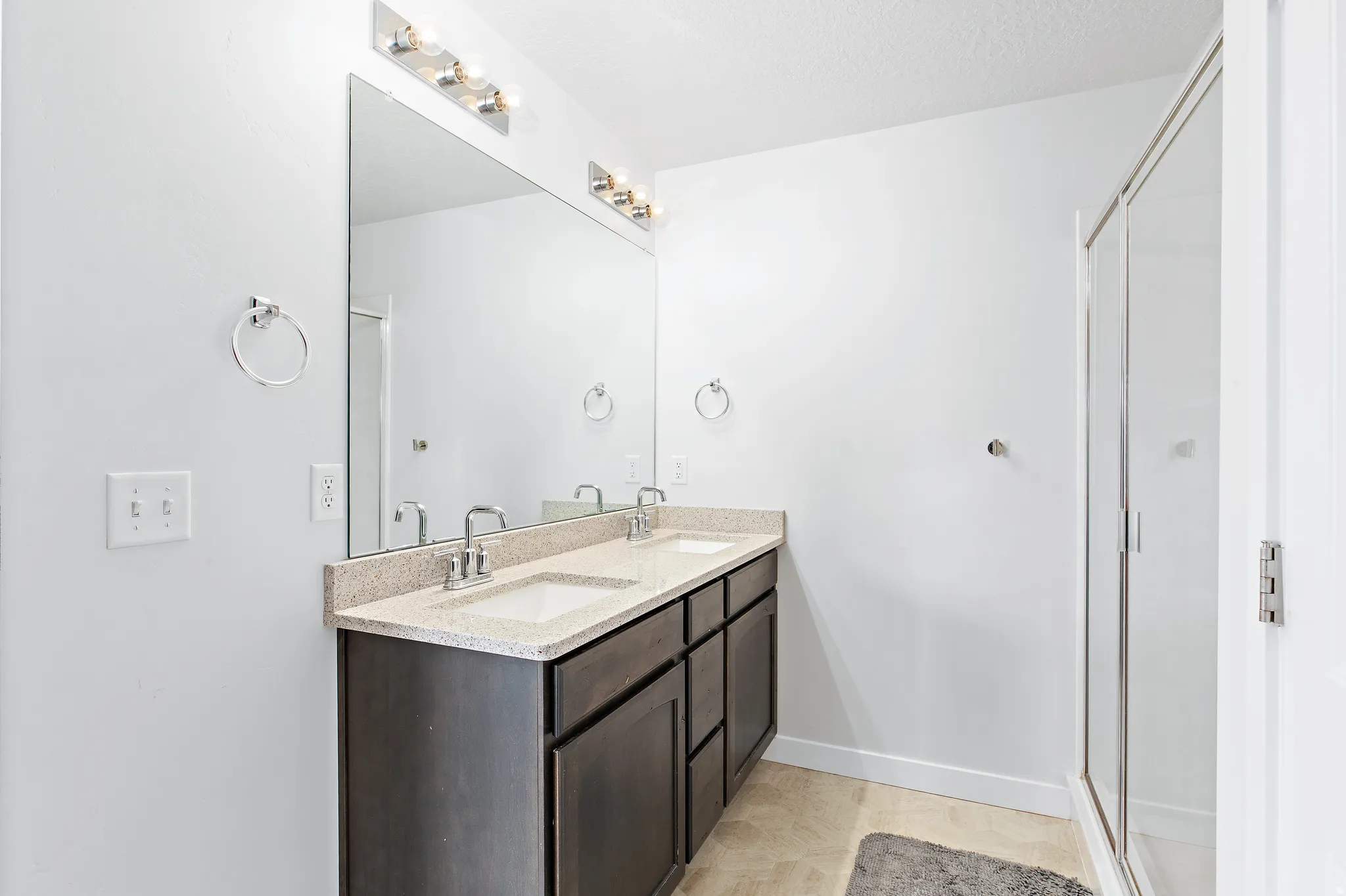 Bathroom with double vanity and a shower stall