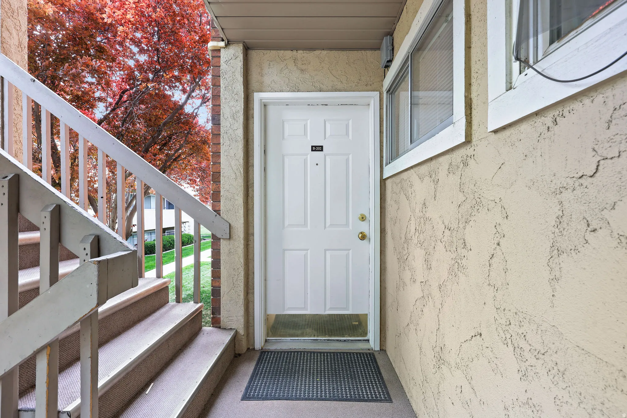 View of exterior entry featuring stucco siding