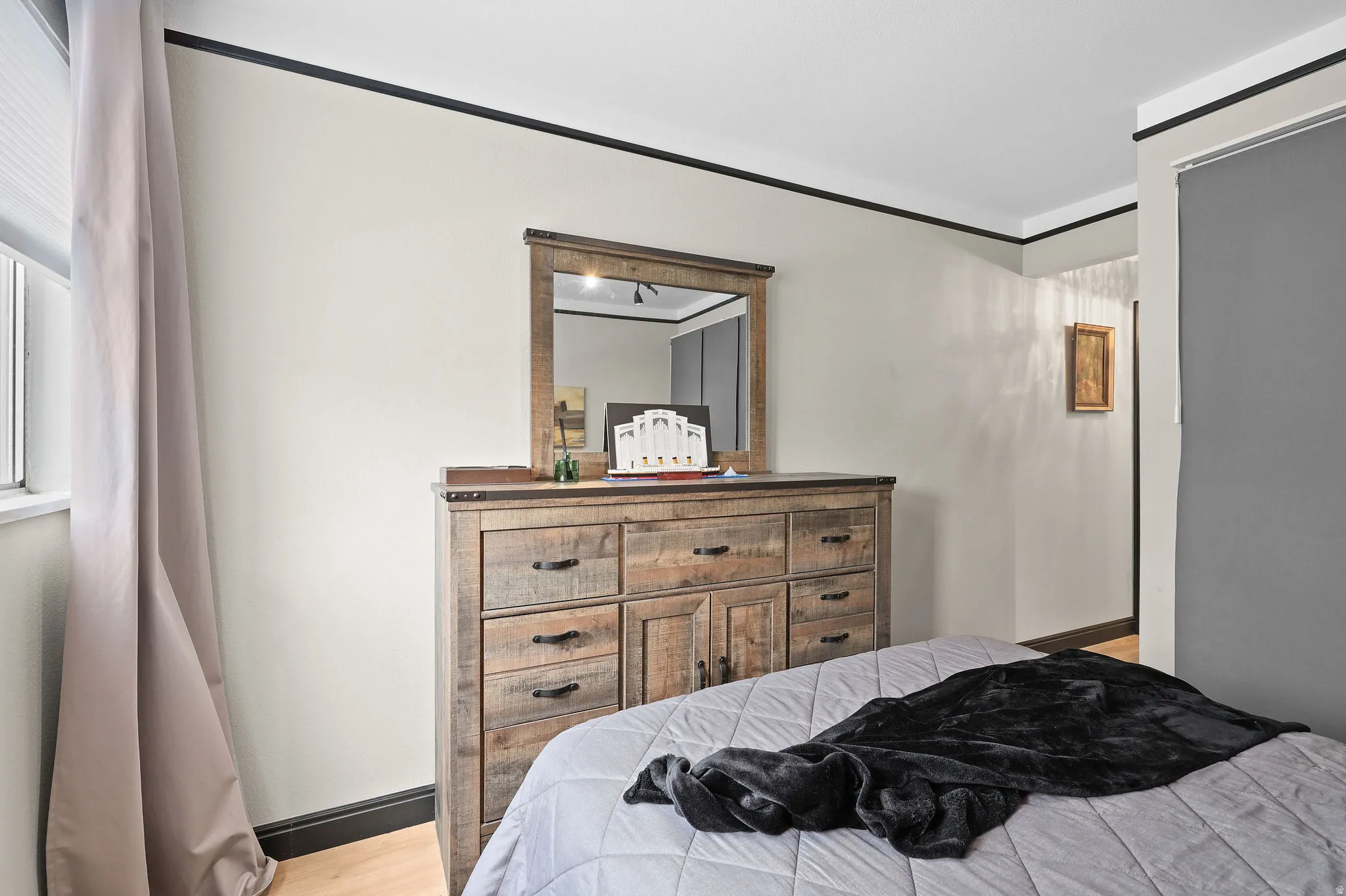 Bedroom with light wood-type flooring and baseboards