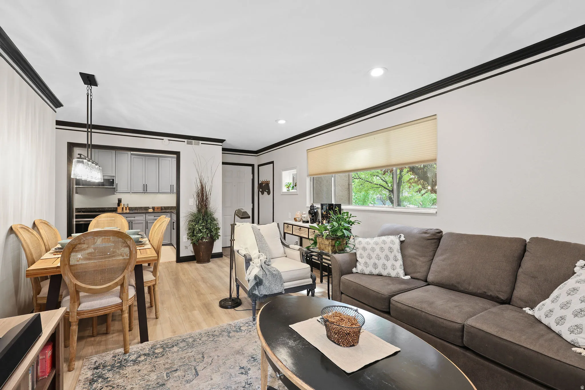 Living area featuring light wood-type flooring, ornamental molding, and recessed lighting