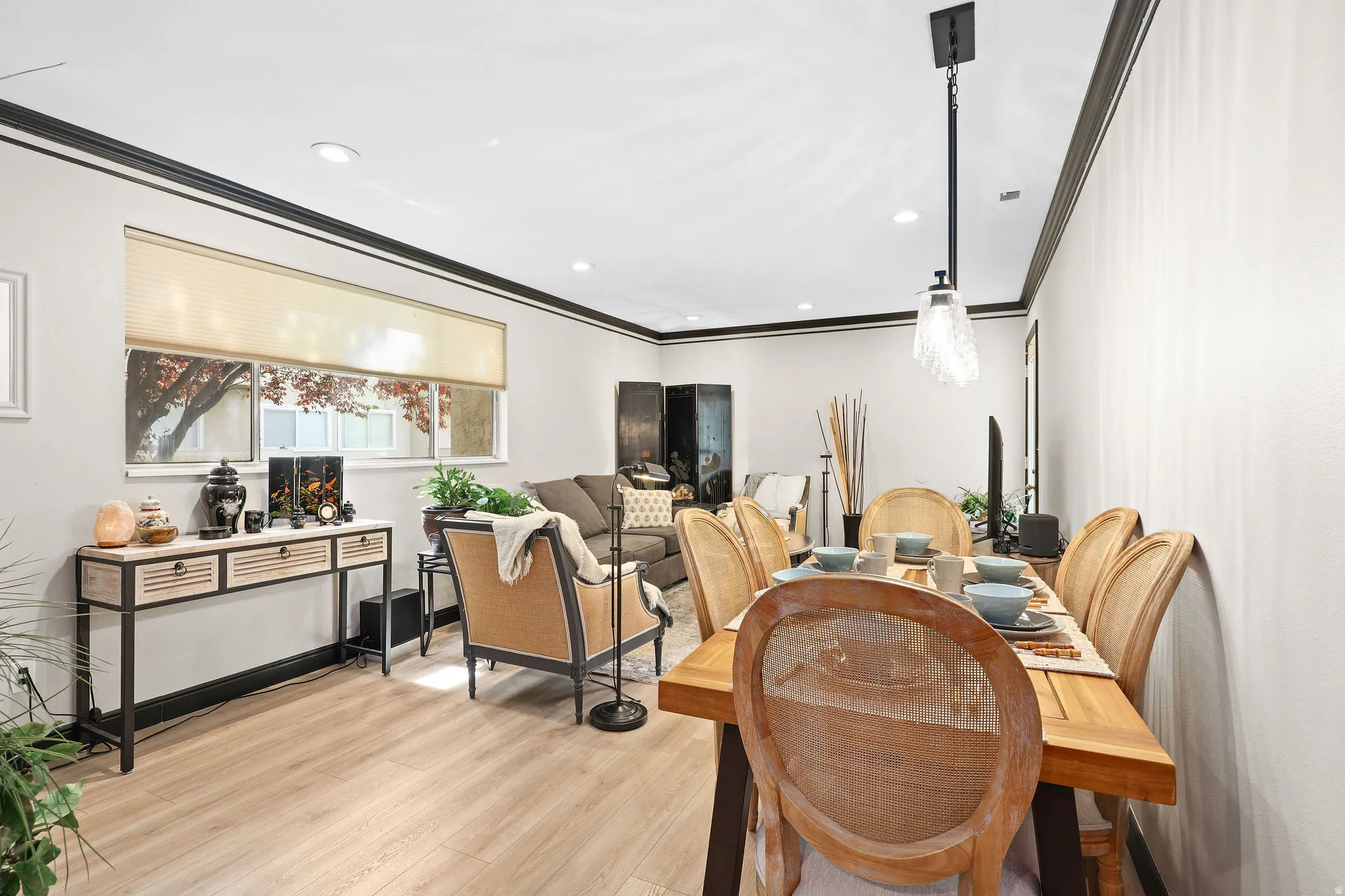 Dining area featuring light wood-style flooring, recessed lighting, and crown molding