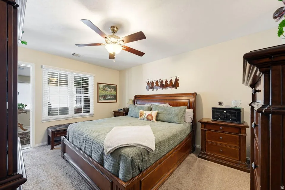 Bedroom featuring ceiling fan and carpet flooring