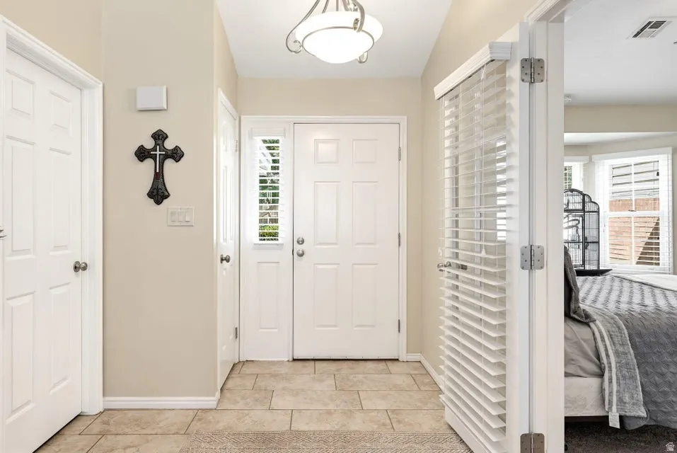 Foyer featuring baseboards and light tile patterned flooring