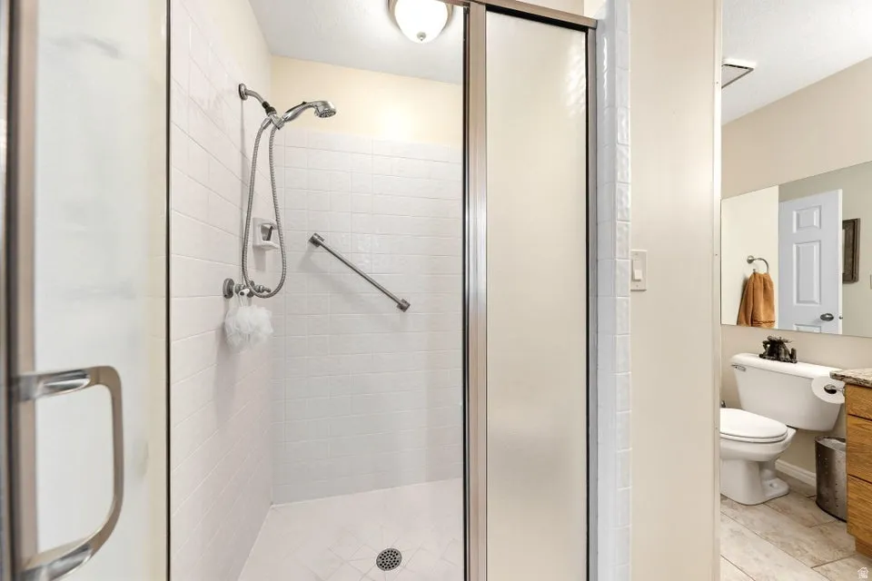 Full bathroom with vanity and a shower stall