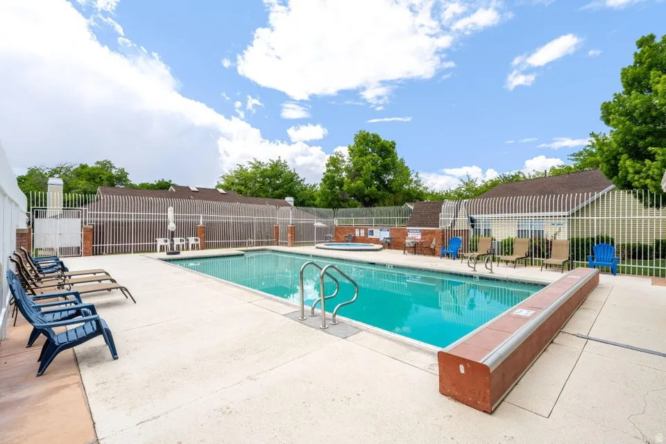 Community pool with a patio