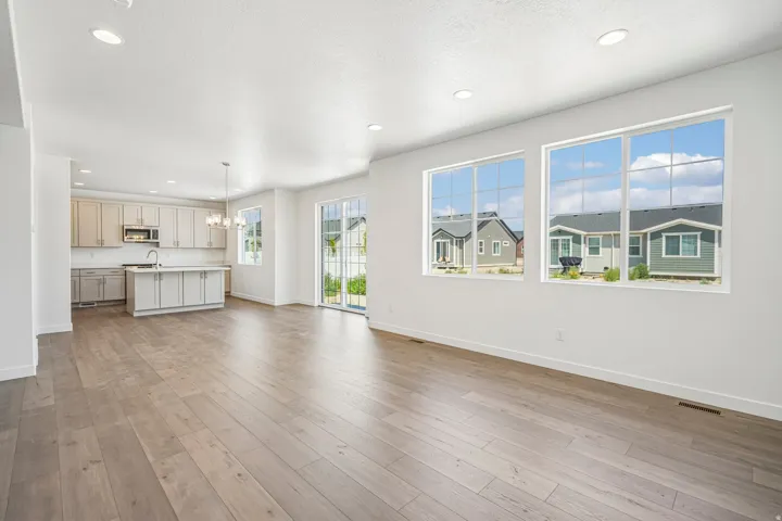 Open concept living area featuring wood-finish flooring