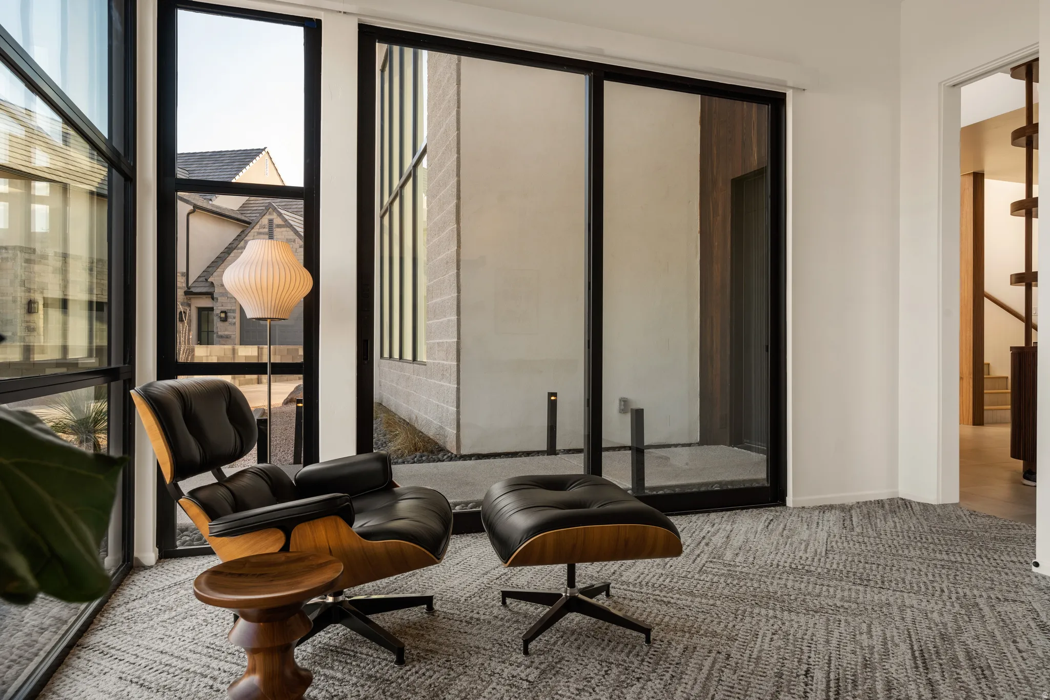 Living area featuring light colored carpet and baseboards