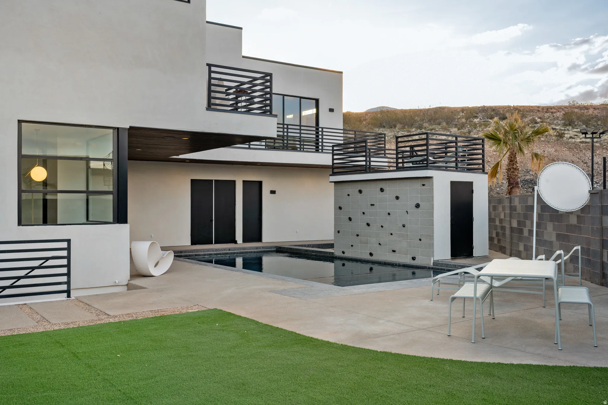 Back of house with stucco siding and a patio area