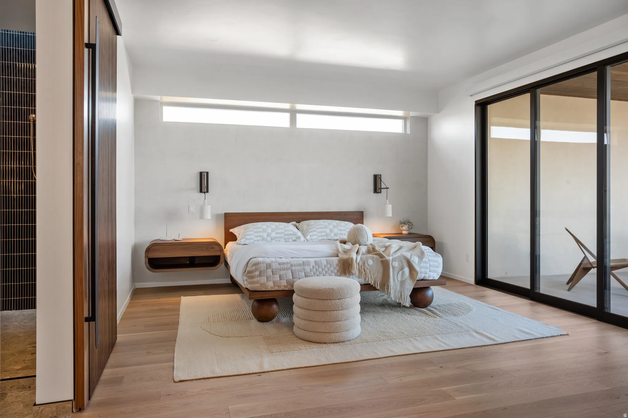 Bedroom with light wood-style flooring and access to outside