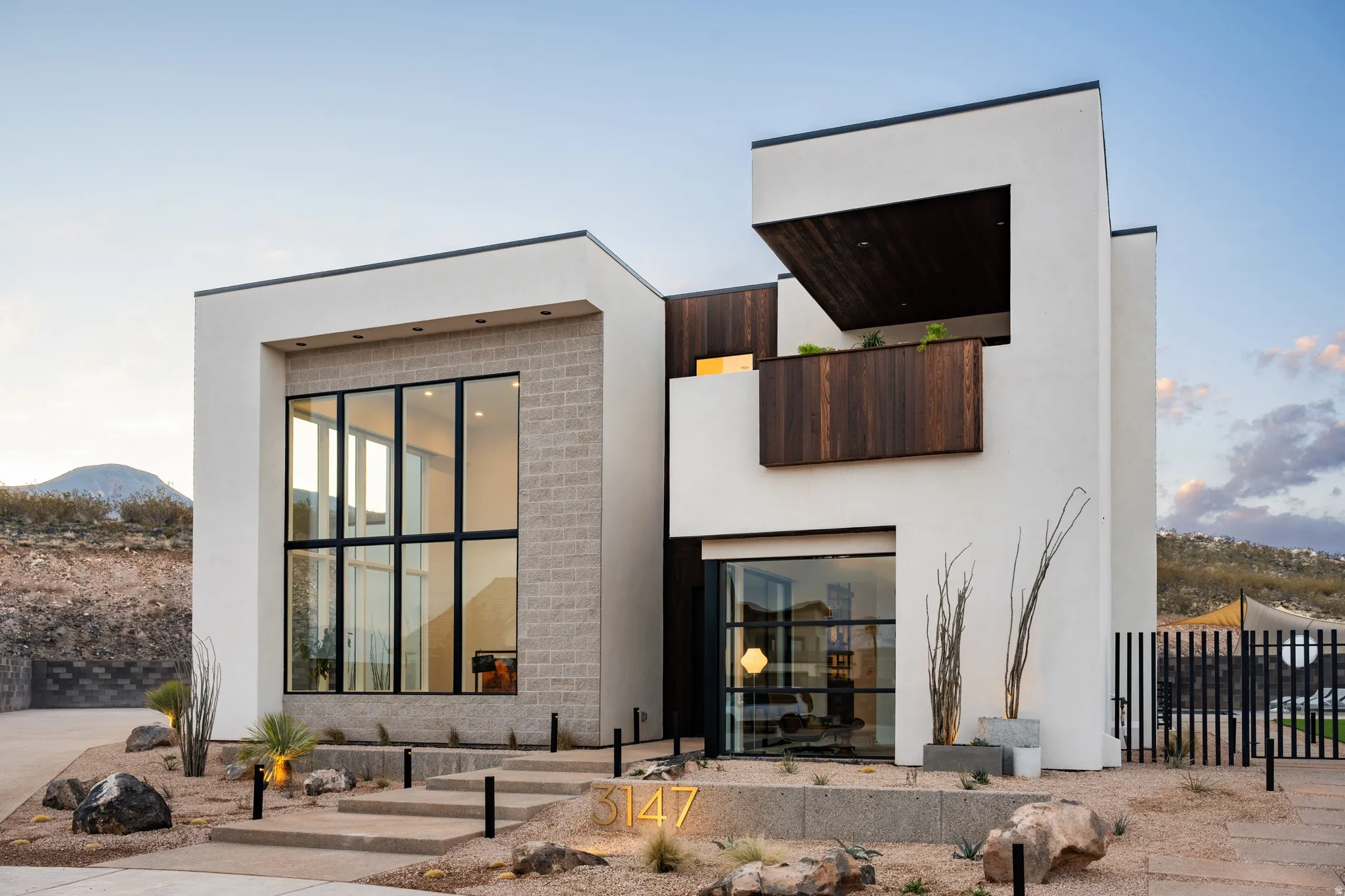 Back of house with stucco siding and a mountain view